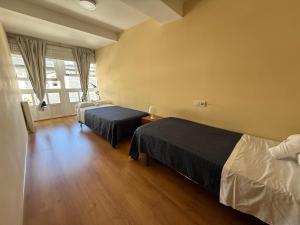 a bedroom with two beds and a window at SP 64 Vut in Lugo