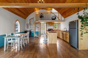 a kitchen and dining room with a table and chairs at Ocean View Chapel Port Rexton with Sauna 2BR in Port Rexton