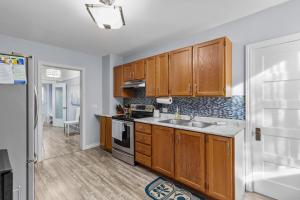 a kitchen with wooden cabinets and a sink at 1942 Boathouse Harbour Views 3 BD Parking in St. John's