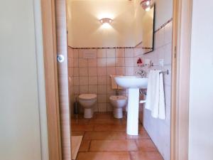 a bathroom with a sink and a toilet at Santu Paulu Country House in Posada