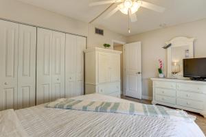 a bedroom with a bed and a flat screen tv at Bayfront South Pasadena Condo with Resort Perks in St Pete Beach +28 photos