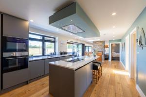 a kitchen with a large island with a stove top oven at lakeside Estate in Bristol
