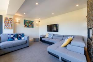 a living room with two couches and a tv at lakeside Estate in Bristol