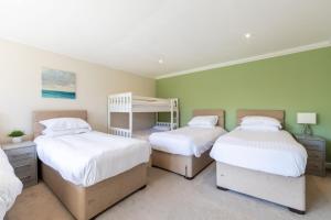 a bedroom with three beds and a bunk bed at lakeside Estate in Bristol
