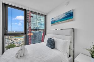 a bedroom with a white bed and a large window at Miami City Lights 2BR 2BA in Miami +20 photos