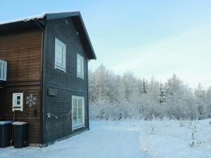 a log cabin with snow on the side of it at Trysil Central Villa in Trysil