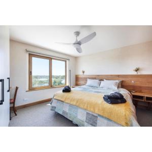 a bedroom with a large bed and a window at Crater View Boutique Eco Apartment in Koroit