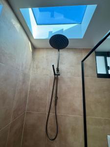 a shower in a bathroom with a skylight at Pacific Sun Bargara in Bargara