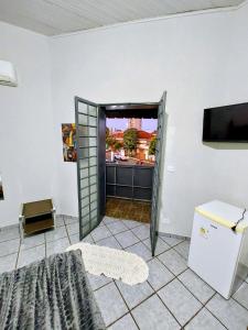 an open door in a room with a refrigerator at Hotel Pasettus in Bela Vista do Paraíso