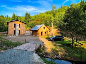 a house and a car parked next to a bridge at U Zlaté Kačenky, wellness chalet in Dobřany