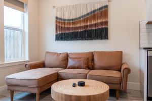 a living room with a couch and a coffee table at New modern home - movie and game room - Family Friendly in Post Falls