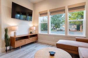 a living room with a couch and two windows at New modern home - movie and game room - Family Friendly in Post Falls