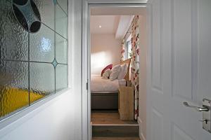 a door leading to a bedroom with a bed at Cornish Dreams in Camborne