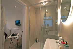 a bathroom with a shower and a sink and a desk at Cornish Dreams in Camborne +34 photos