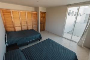 a bedroom with two beds and a large window at Family House with Pool and Jacuzzi in Morelos in Chiconcuac +47 photos