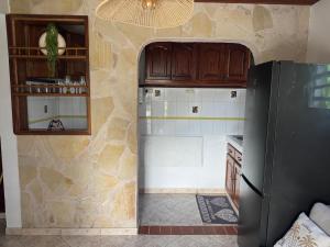 a kitchen with a refrigerator in a room at F2 moderne et tranquille in Saint-Joseph