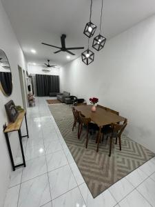 a living room with a table and a couch at Zh homestay teluk batik in Lumut +7 photos