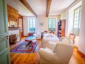 a living room with white furniture and a fireplace at Beautiful farmhouse with private pool in Le Houga +32 photos