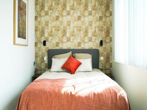 MontenakenPeaceful holiday home near Hannut的卧室内的一张带两个红色枕头的床 更多32张照片