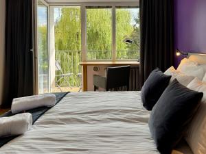 een groot bed in een kamer met een groot raam bij Apartament Kochanowskiego Łódź in Łódź