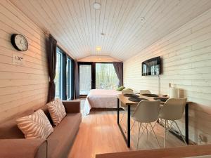 a room with a bed and a couch and a table at Villa Kutula in Hossa
