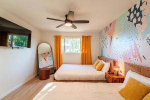 a bedroom with two beds and a ceiling fan at Ella Oasis Heated Pool Hot Tub Near Old Town in Scottsdale +53 photos