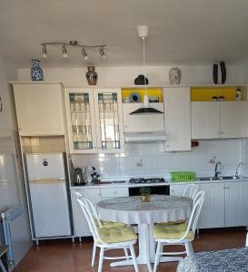 a kitchen with a table and chairs and a refrigerator at Apartments with parking space Rabac, Labin - 7438 in Rabac +18 photos
