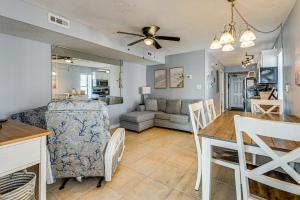 a dining room and living room with a table and chairs at Ocean-View Penthouse Condo in North Myrtle Beach! in Myrtle Beach