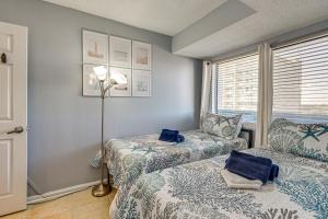 a bedroom with two beds and a lamp and a window at Ocean-View Penthouse Condo in North Myrtle Beach! in Myrtle Beach +28 photos