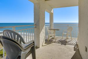 a balcony with chairs and a table and the ocean at Ocean-View Penthouse Condo in North Myrtle Beach! in Myrtle Beach