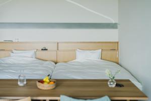 Ένα ή περισσότερα κρεβάτια σε δωμάτιο στο SANU 2nd Home Izu 1st