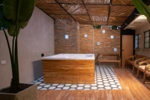 a large bath tub in a room with a table at CasaSue Living & Hotel in Bogotá