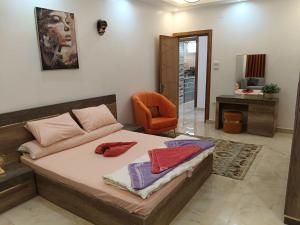 a bedroom with a bed and a chair at Nile View Dreams Apartment in Aswan