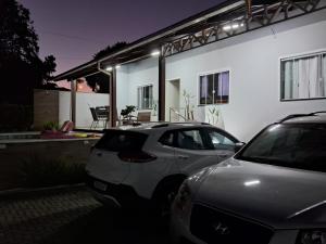 a car parked in front of a house at night at Casa com piscina, suite com hidro em Blumenau in Blumenau