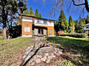 a house on a hill with a stone path in front at 閼宗屋 Asoya in Takamori