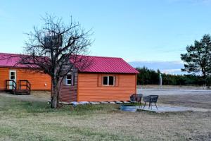 a house with a red roof next to a tree at Peninsula Point Lodge in Rapid River