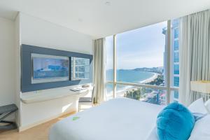 a hotel room with a bed and a large window at Diamond Bay Hotel in Nha Trang +66 photos