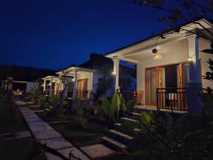 Umaku Bali Homestay في Gobleg: منزل ليلاً مع أضواء على الشرفة