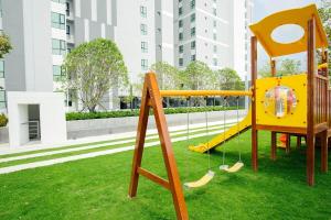 a playground in a park with a yellow swing at The Base 88-67 F5 in Pattaya