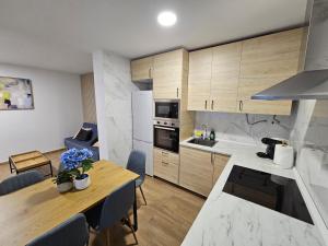 a kitchen and dining room with a table and a dining room at Casa Hernán Cortés in Málaga