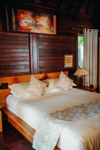Habitación con 2 camas y paredes revestidas de madera. en Kubu He Mamatica, en Tianyar 36 fotos más