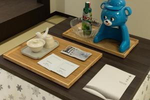 a table with two trays with a blue bear on it at Stay Passport Sapporo Ryokan Seoul Hongdae in Seoul