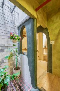 a bathroom with two arches and a plant in a room at Cozrum Homes - Yoga Corner in Ho Chi Minh City