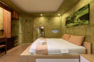 a bedroom with a large bed and a shower at Cozrum Homes - Yoga Corner in Ho Chi Minh City