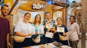 a group of people posing for a picture with their certificates at SD3M ART GALLERY Villa in Dickwella