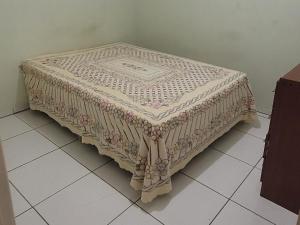 a table with a blanket on it sitting on a floor at Terraço do Sol Apt 01 in Marcelino Ramos