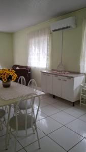 a living room with a table and chairs and a room at Terraço do Sol Apt 01 in Marcelino Ramos