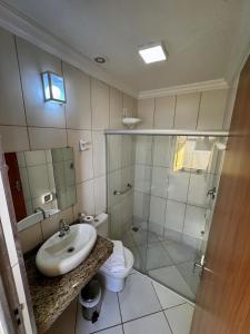 a bathroom with a sink and a toilet and a shower at Imperial Cidade Smart Suítes in Ouro Preto