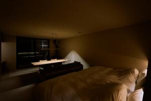 a bedroom with a bed and a desk and a window at SANU 2nd Home Nasu 3rd in Nasu
