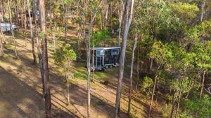 an aerial view of a tent in the middle of a forest at Hidden Camp's Loft House by Tiny Away in Kanighan